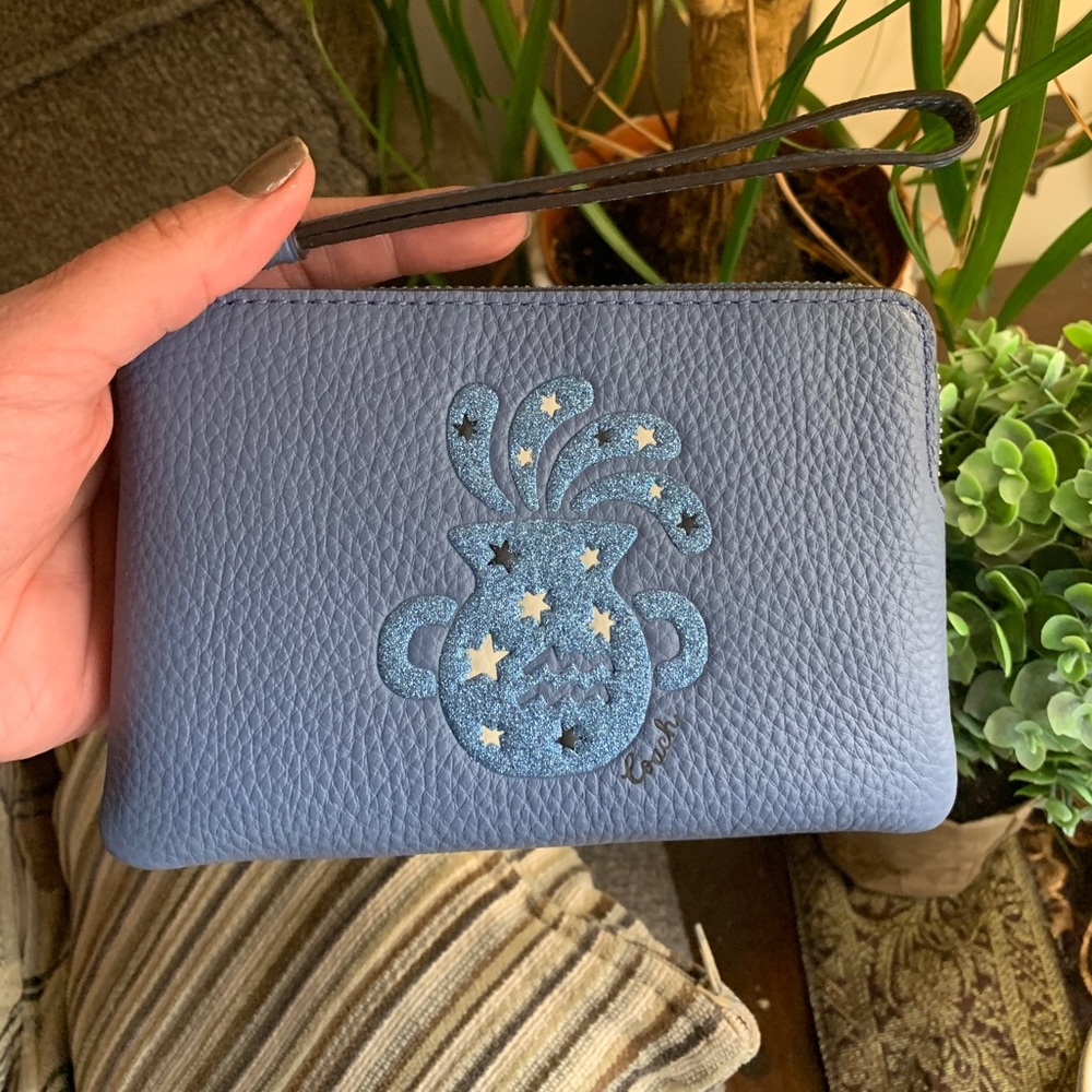 Authentic COACH Pebbled leather zip wristlet with Aquarius print
